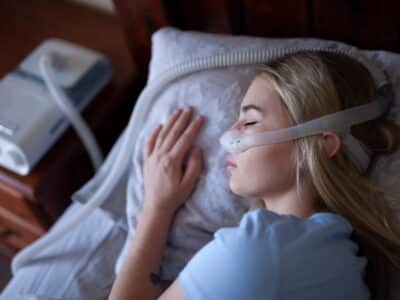 Woman sleeping with CPAP machine